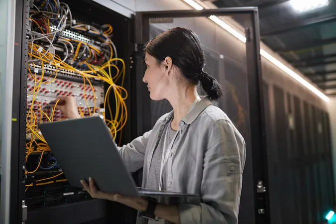 Waist Up Female Network Engineer Connecting Cables Server Cabinet While Working With Supercomputer Data Center Copy Space - Aruba Certified Switching Professional study guide