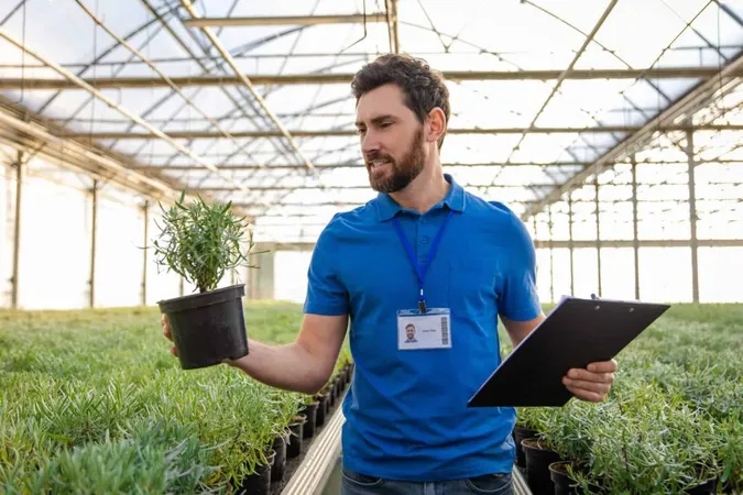 Smiling Bearded Young Caucasian Man With Potted Plants Hands Greenhouse X - Associate Environmental Professional Certification study guide