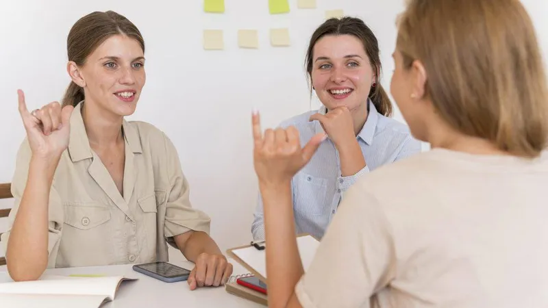 Smiley Women Conversing Table Using Sign Language X - Certified American Sign Language Instructor study guide