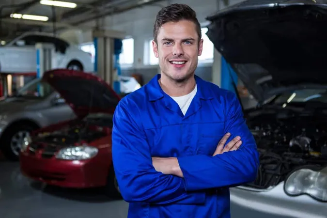 Mechanic Standing Repair Garage X - Audi Certified Mechanic study guide