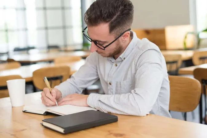 Focused Male Student Writing Not 1 - Blog study guide