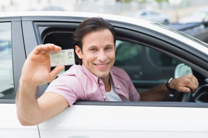 Man Smiling Holding His Driving 1 1 - Blog study guide