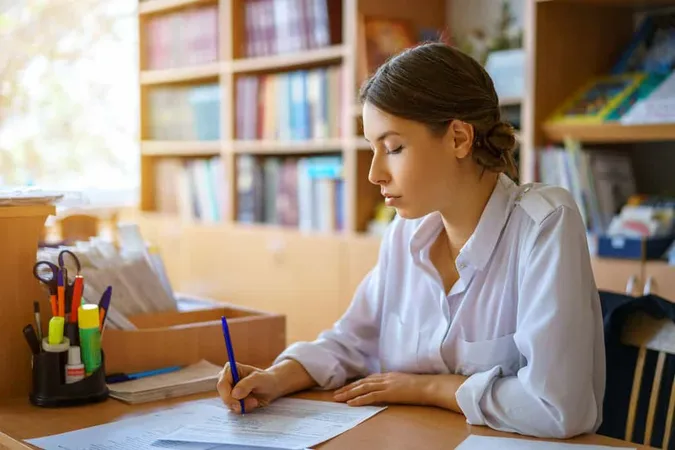 Young Woman Sitting Table White - Blog study guide