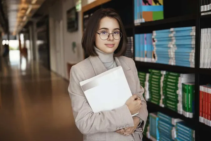 Successful Young Woman Enrolled University Studying Hard Get Degree Working Project Holding Documents Smiling Camera With Relaxed Expression Standing Near Piles Books Hall X - Certified Archivist Certification study guide