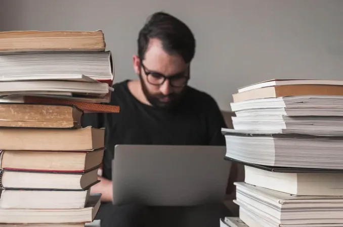 Man Using Laptop Near Books X - California Real Estate Exam study guide