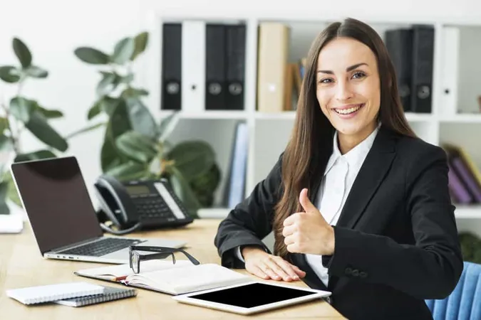 Smiling Young Businesswoman Sitting Workplace Showing Thumb Up Sign X - Certified Acceptance Agent study guide