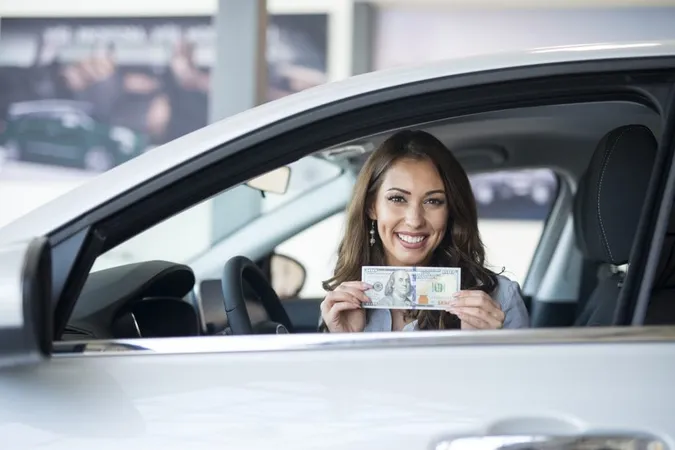 Cheerful Woman Sitting New Car Holding Us Dollar Banknote X - Certified Asset Recovery Specialist study guide