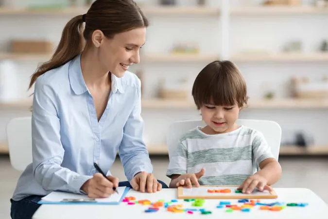 Professional Woman Language Teacher Exercising With Preschooler Little Boy Making Word With Letters X - Certified Autism Specialist study guide