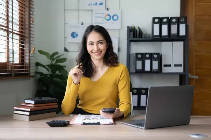 Smiling Beautiful Asian Businesswoman Analyzing Chart Graph Showing Changes Market Holding Smartphone Office X - Certified Budget Analyst study guide