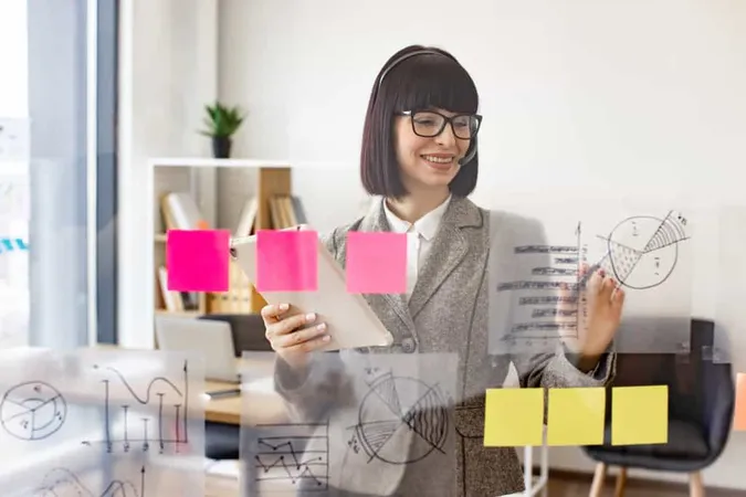 Woman Headphones Writing Transparent Board With Sticky Papers X - Certified Brand Manager study guide