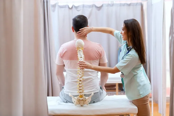 Beautiful Female Doctor Holding Spine Model Examining Patient S Spine X - Certified Biophysics Chiropractic study guide