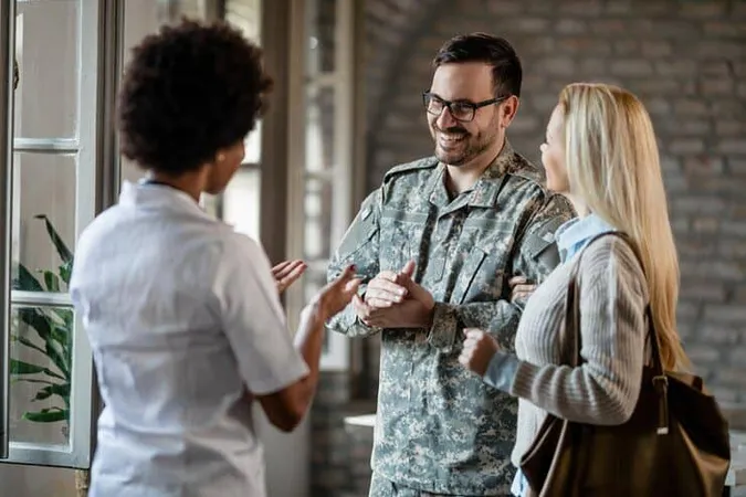 Happy Army Soldier His Wife Communicating With African American Healthcare Worker While Having Consultations Clinic - Certified Chaplain Assistant study guide