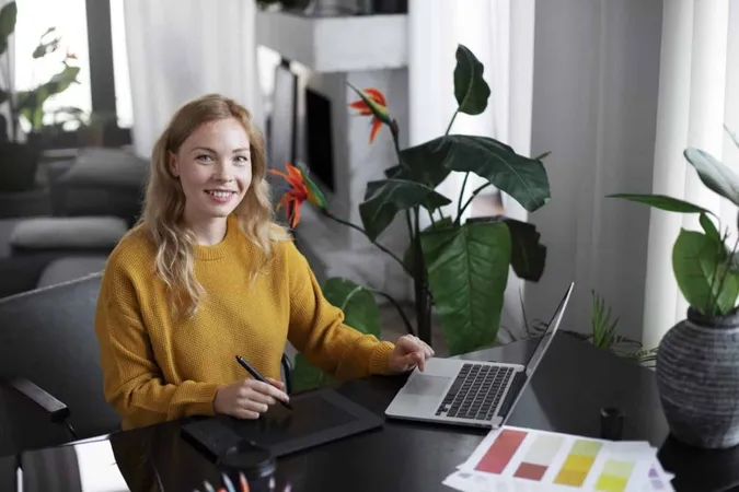 Logo Designer Working Her Tablet Connected Laptop X - Canva Certified Creative study guide