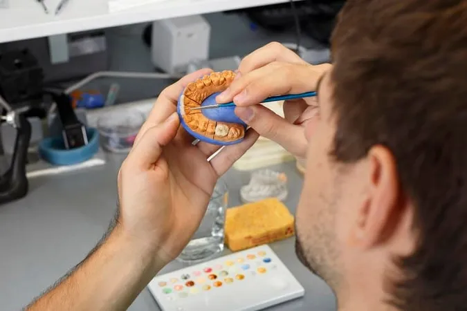 Technician Manually Paints Veneers Model - Certified Ceramist study guide