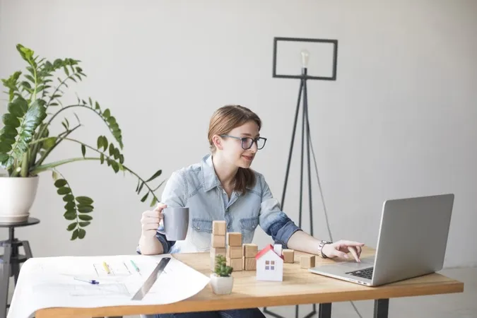 Smiling Attractive Woman Holding Coffee Cup While Working Laptop X - Certified Community Manager study guide