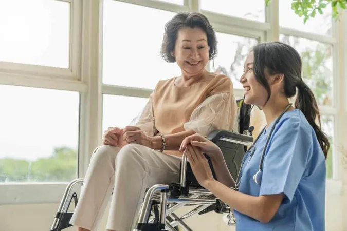 Asian Young Caregiver Caring Her Elderly Patient Senior Daycare Handicap Patient Wheelchair Hospital Talking Friendly Nurse Looking Cheerful Nurse Wheeling Senior Patient X - Certified Care Specialist study guide