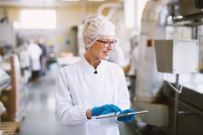 Smiley Female Worker Sterile Clothes Using Tablet Checking How Production Line Is Working X - Certified Culinary Scientist study guide