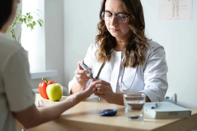 Doctor Shows Patient How Use Glucometer Female Endocrinologist Is Seeing Patient Her Office Topic Measuring Blood Sugar Levels X - Certified Diabetes Care and Education Specialist study guide