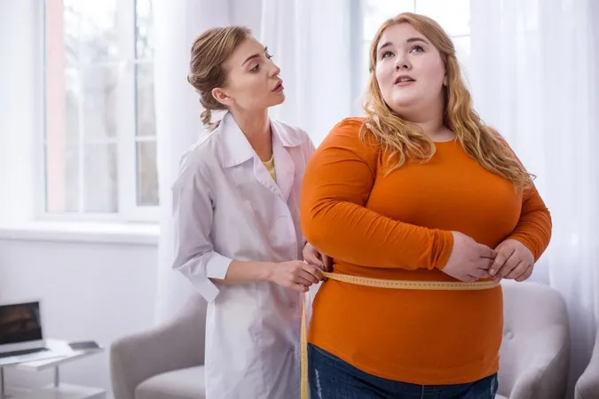 Big Weight Serious Professional Doctor Talking With Fat Woman Measuring Her X - Certified Bariatric Counselor study guide