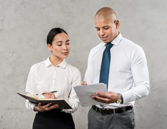 Business Partners Team Employees Discussing Documents Ideas Standing Against Grey Wall X - Certified Business Advisor study guide
