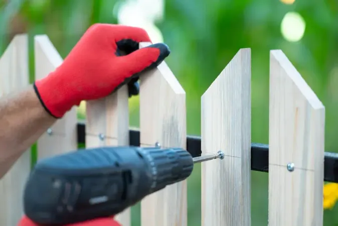 Onlinejsonformatter. Man Hands Working Gloves Building Wooden Fence With Help Electric Screwdriver Close Up Large - Certified Fence Installer study guide
