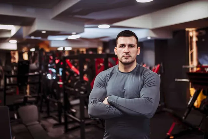 Portrait Strong Muscular Man Gym Standing With His Arms Crossed Looking Camera X - Certified Fitness Professional study guide
