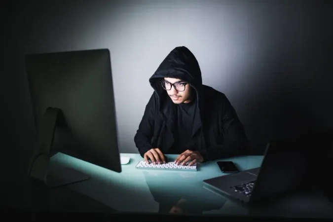 Indian Hacker Dark Hoody Sitting Front Notebook Computer Privacy Attack X - Certified Fraud Specialist study guide