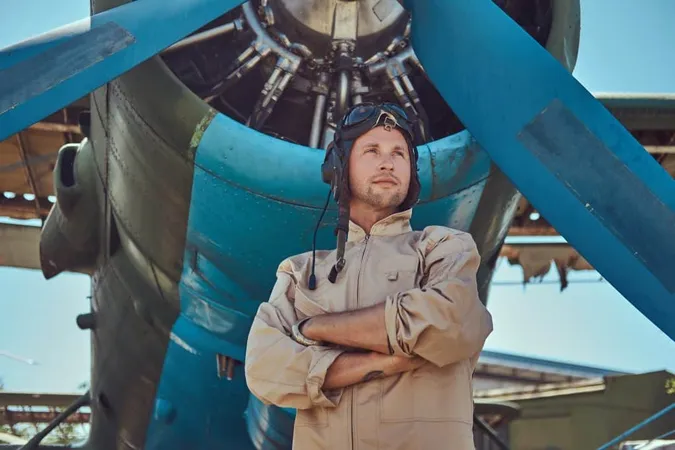 Handsome Pilot Full Flight Gear Standing With Crossed Arms Near Military Airplane X - Certified Ground Instructor study guide
