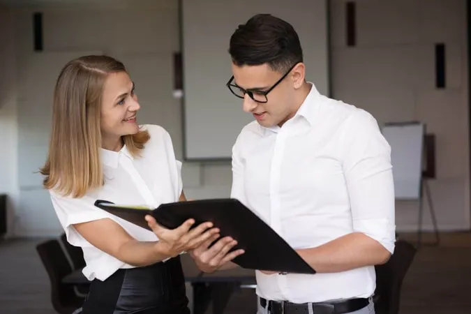 Smiling Businesswoman Showing Folder With Document Businessman X - Certified Intervention Professional study guide