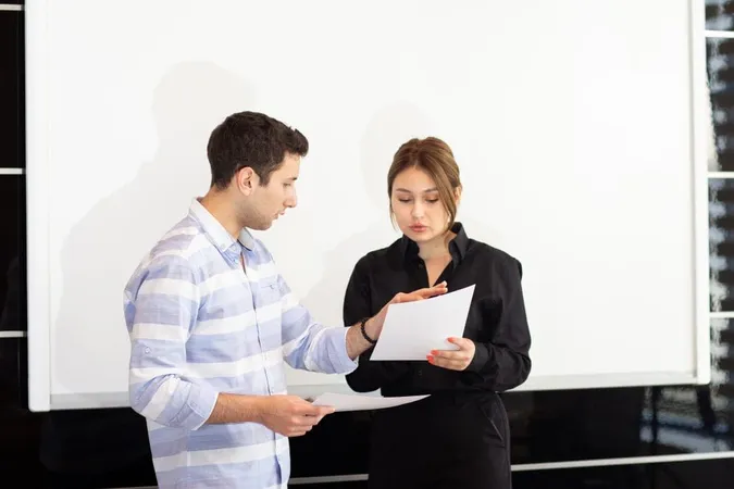 Front View Young Attractive Businesswoman Black Shirt Along With Young Man Discussing Graphics Desk While Young Lady Presents Her Work Reading Document Job Building Presentation X - Certified Interpretive Trainer study guide