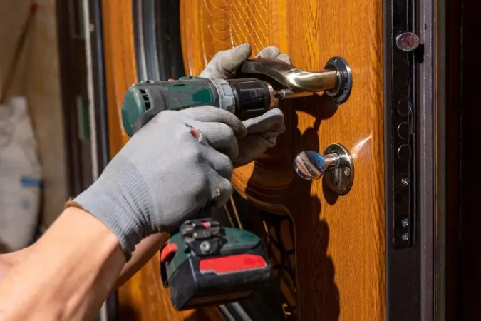 Master Worker Installs Lock Front Door Metal Doors With Polymer Coating X - Certified Master Locksmith study guide