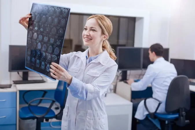 Happy Beautiful Attractive Oncologist Holding X Ray Examining It While Seeing Nothing Bad 1 X - Certified Neuro Specialist study guide