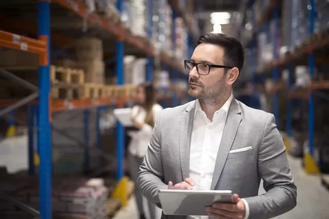 Portrait Successful Businessman Manager Ceo Holding Tablet Walking Through Warehouse Storage Area Looking Towards Shelves X - Certified Operations Manager study guide