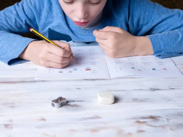 Young Boy Sat Table Home Studying Doing Homework X - Canadian Open Mathematics Challenge study guide