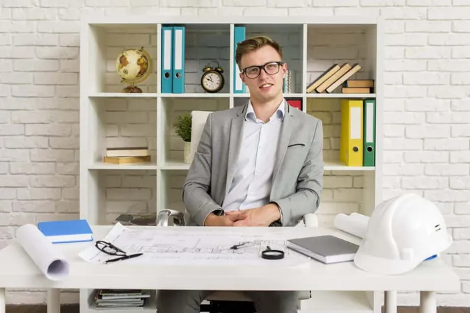 Serious Young Specialist Posing Camera X - Certified Professional Estimator study guide
