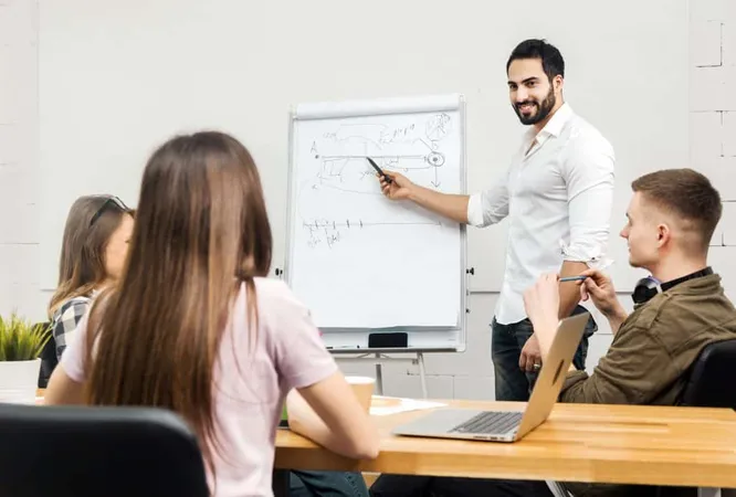 Team Office Workers Discussing Diagrams Before Flip Chart Board Indoor Shot Modern Office X - Certified Professional Instructor study guide