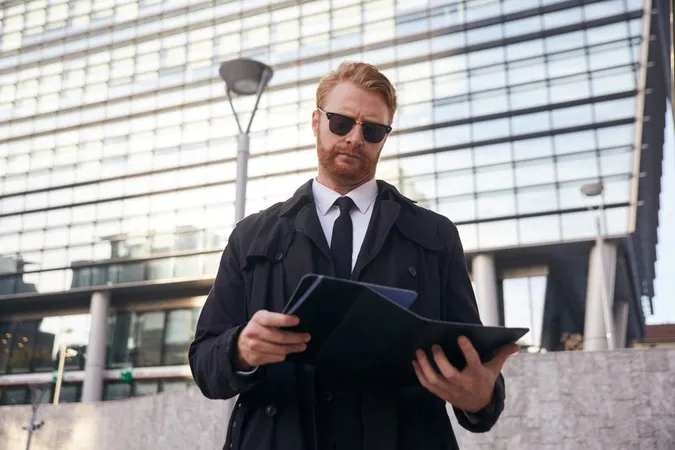 Low Angle View Man Wearing Sunglasses Holding Digital Tablet Standing Outdoors X - Certified Professional Investigator study guide