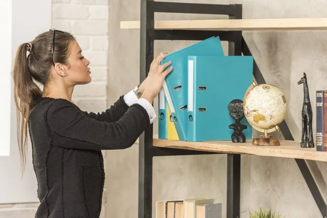 Brunette Businesswoman Taking Folder X - Certified Professional Organizer study guide