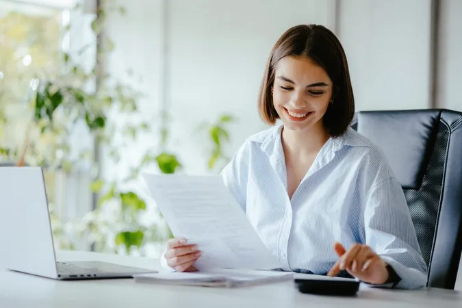 Accountant Woman Doing Work Her Desk With Paper Calculator X - Certified Payroll Specialist study guide