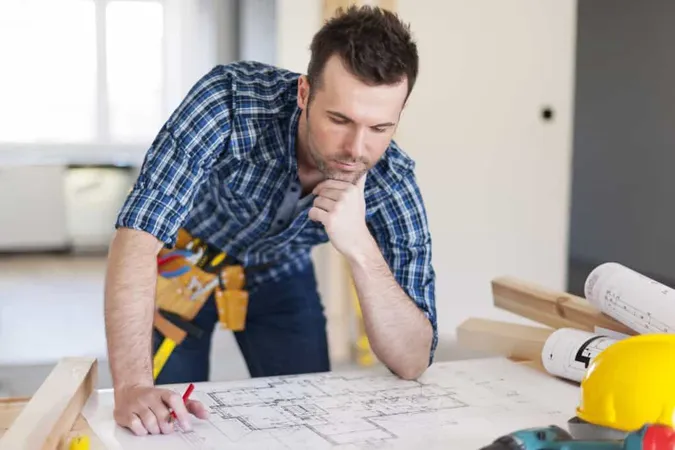 Building Contractor Bending Home Plans X - Certified Residential Contractor study guide