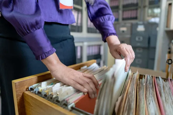 Midsection Woman Removing File Office X - Certified Records Management study guide