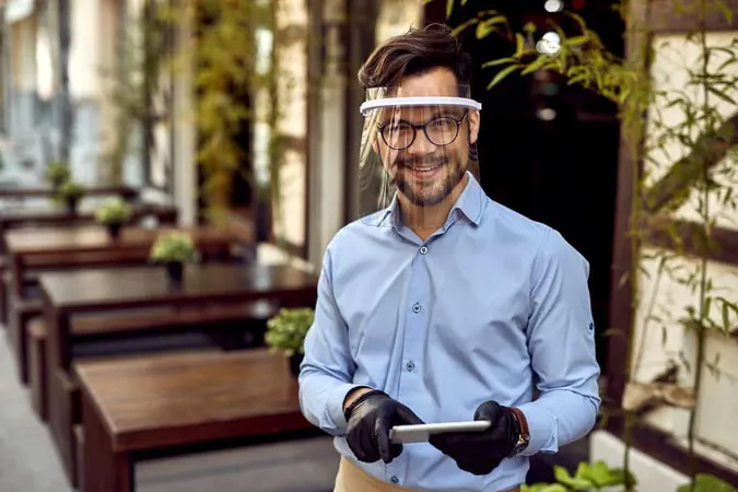Happy Waiter Wearing Visor While Working Touchpad Outdoor Cafe Looking Camera X - Certified Recreation Professional study guide