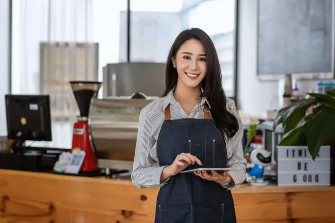 Young Asian Businesswoman Owner Standing Holding Tablet Front Coffee Shop Cooking Beverage Looking Camera X - Certified Sales Associate study guide