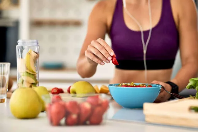 Closeup Athletic Woman Adding Strawberries While Making Fruit Salad Kitchen X - Certified Sports Nutritionist study guide