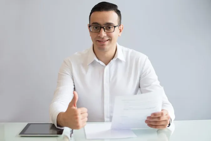 Successful Young Businessman With Document Showing Thumbs Up X - Certified Tax Coach study guide