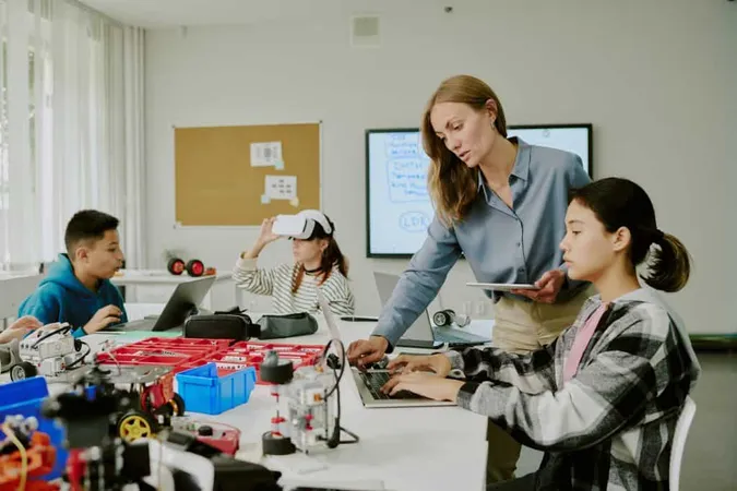 Female Teacher With Tablet Helping Young Programmer With Codes While Other Students Enjoying Vr X - Certified Teacher Career and Technical Education study guide