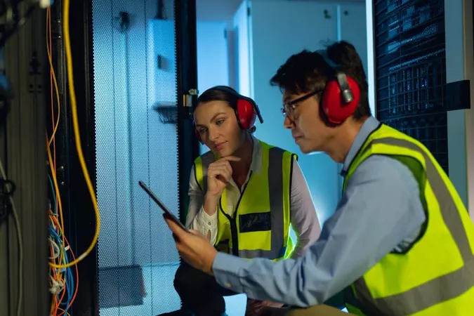 Diverse Male Female Engineer Using Digital Tablet While Inspecting Computer Server Room Database Server Management Maintenance Concept X - Certified Telecommunications Executive study guide