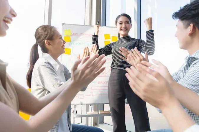 Woman Gesturing While Colleagues Applauding Meeting X - Certified Team Leader study guide