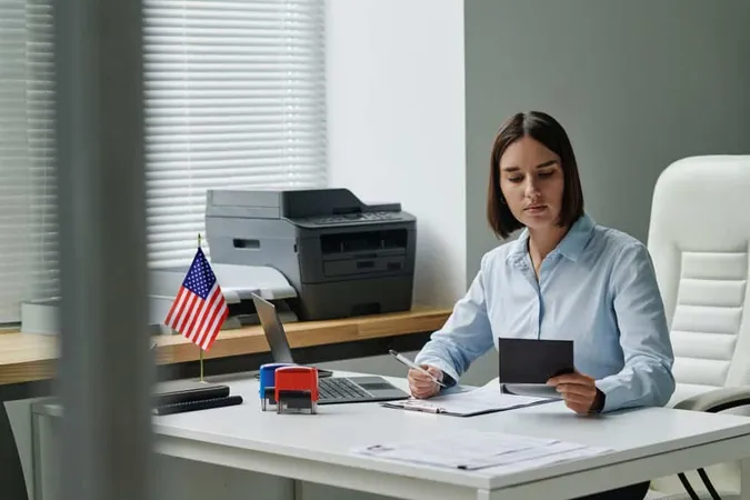 Young Specialist Making Visa Tourists She Sitting Her Workplace Checking Documents X - Certified Tax Resolution Specialist study guide