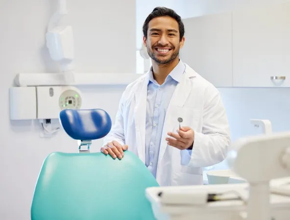 Confident Middle Aged Asian Male Dentist Posing Clinic X - Doctor of Dental Medicine study guide